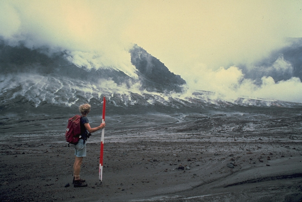 Volcanologist Haraldur Sigurdsson observes a growing lava dome in the summit crater of Soufrière volcano in November 1979 during a field expedition to conduct geodetic surveys of the dome.  By the end of the eruption in October 1979 the dome reached a height of 130 m. Photo by Richard Fiske, 1979 (Smithsonian Institution).