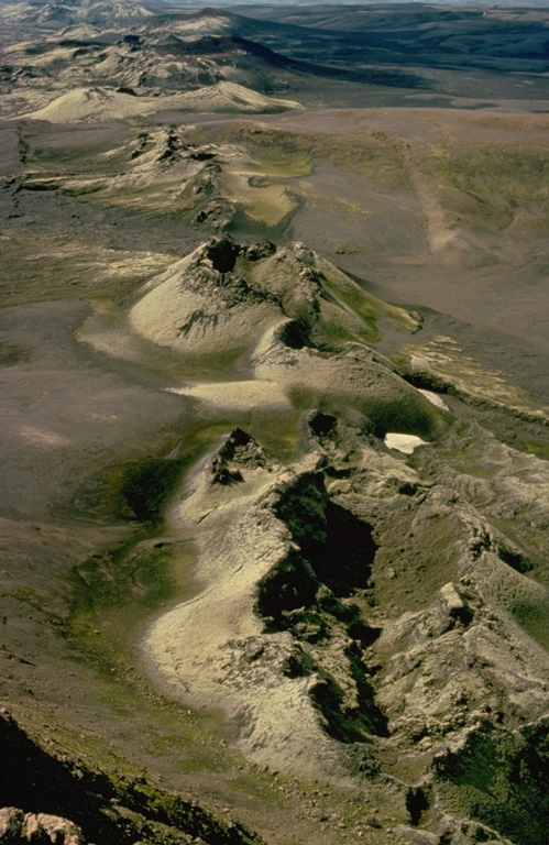 The most prominent of a series of fissures extending from Grímsvötn central volcano is the noted Laki (Skaftár) fissure, seen here, which trends to the SW.  It produced the world's largest known historical lava flow during an eruption in 1783.  Grímsvötn, Iceland's most frequently active volcano during historical time, lies largely beneath the vast Vatnajökull icecap.  The caldera lake is covered by a 200-m-thick ice shelf, and only the southern rim of the 6 x 8 km caldera is exposed.  Copyrighted photo by Katia and Maurice Krafft, 1975.