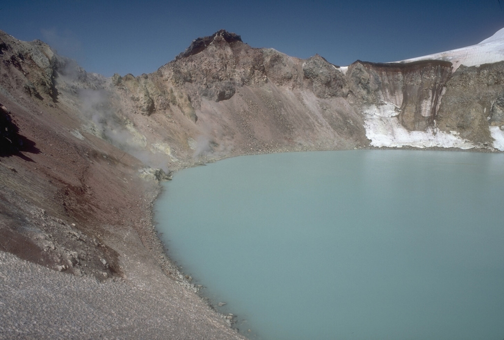 A plume emitting from active fumaroles is on the N side (left center) of the summit lake at Douglas volcano on the northern tip of the Alaska Peninsula. The small, 160-m-wide crater is one of the few ice-free areas on Douglas volcano. In 1992, the lake had a pH of 1.1 and a temperature of 21°C. Photo by Chris Nye (Alaska Division of Geological and Geophysical Surveys).