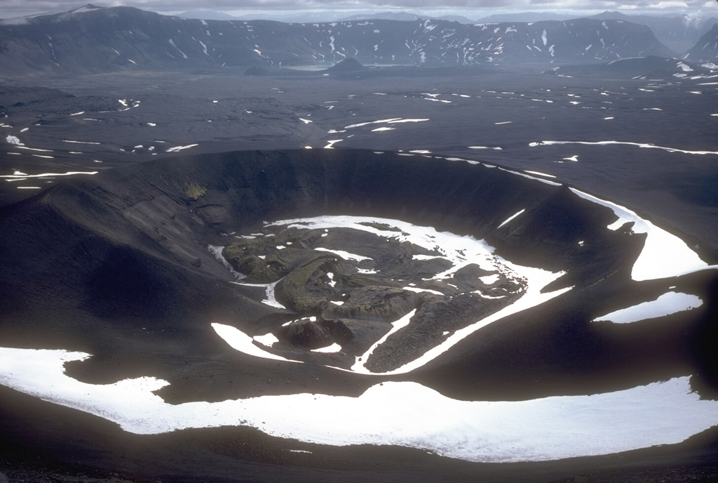 The primary Aniakchak 1931 eruption site is against the NW caldera wall. This 600-m-wide crater produced intermittent explosions of pumice-lithic tephra over the course of several weeks in May and June 1931. During the final phases of the eruption a small lava flow formed in the bottom of the crater. The fissure eruption cut through Vent Mountain and across the caldera floor to the western caldera wall. Photo by Game McGimsey, 1992 (Alaska Volcano Observatory, U.S. Geological Survey).