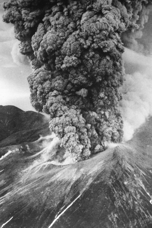 An ash plume erupts from Tokachidake on 30 June 1962. A phreatic explosion on 29 June killed five sulfur mine workers and was followed by a magmatic eruption three hours later. It continued for 11 hours, producing a 12-km-high ash plume. Weak eruptions continued intermittently until September.   Photo by Asahi Shimbun, 1962 (courtesy of Mario Yoshida, Hokkaido University).