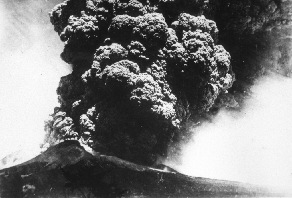 A Plinian eruption column rises above Komagatake volcano in northern Japan on 17 June, the beginning of a major eruption in 1929 that was one of the largest in historical times. The ash plume rose to a maximum height of 13 km and produced thick, pumice-rich fall deposits around the volcano. The eruption also produced pyroclastic flows that traveled down the flanks. This photo is from the shores of Onuma lake to the south. Photo courtesy of the Komaga-take Disaster Prevention Council, 1929.