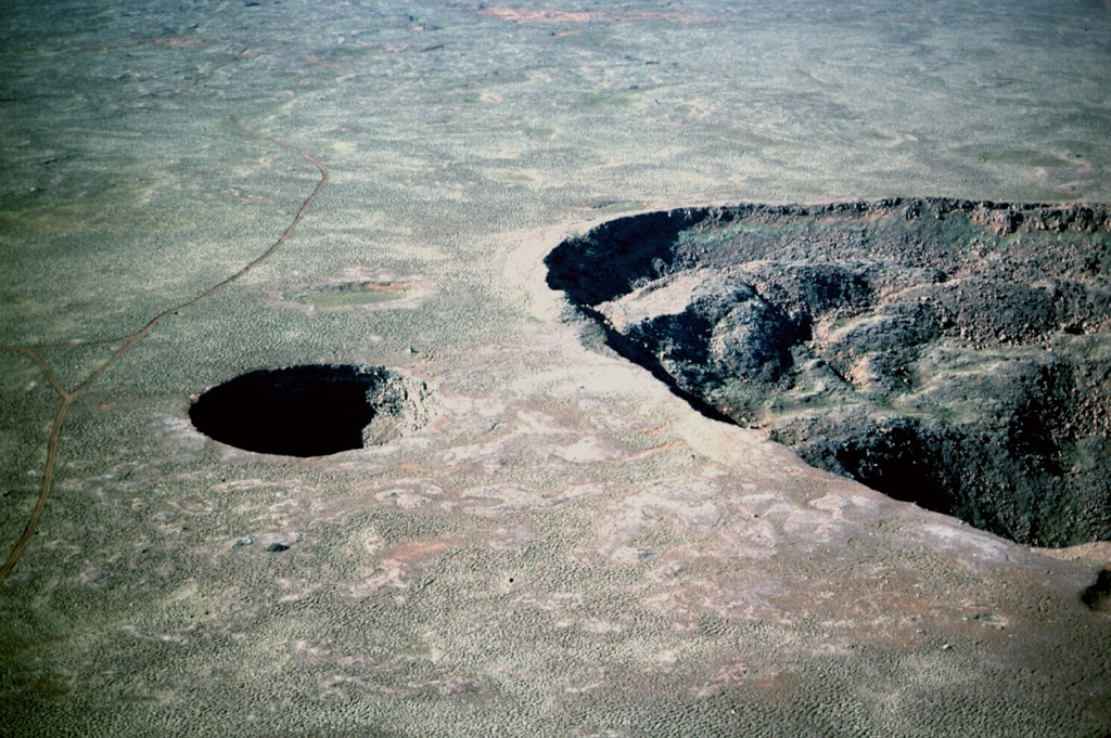 The small Litlavíti pit crater (left) lies immediately SSW of Stóravíti crater (right) near the summit of the Theistareykjarbunga shield volcano. The very low-angle volcano is part of Theistareykir, the northernmost subaerial volcanic system of Iceland's Eastern Volcanic Zone. Photo by Michael Ryan, 1984 (U.S. Geological Survey).