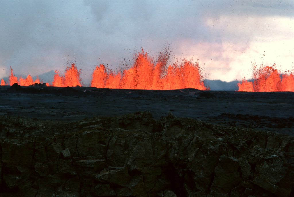 Incandescent lava fountains rise from an eruptive fissure at Krafla volcano in NE Iceland on 6 September 1984. After a quiet interval of 33 months, an eruption began on 4 September along a fissure extending from Leirhnjúkur 8.5 km N. Initially, the fissure was active along its entire length, but later lava production was highest at the northern end. Photo by Michael Ryan, 1984 (U.S. Geological Survey).