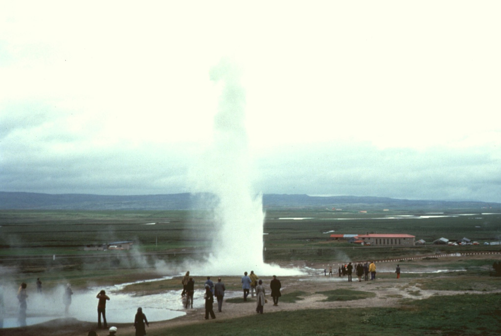 The Geysir thermal area, containing Iceland's largest geysers, lies in the Haukadalur basin, just east of the southern end of the extensive Oddnyjarhnjukur-Langjokull volcanic system. Here a geyser can be seen ejecting water and steam to about 20 m high. Photo by Bill Rose, 1975 (Michigan Technological University).