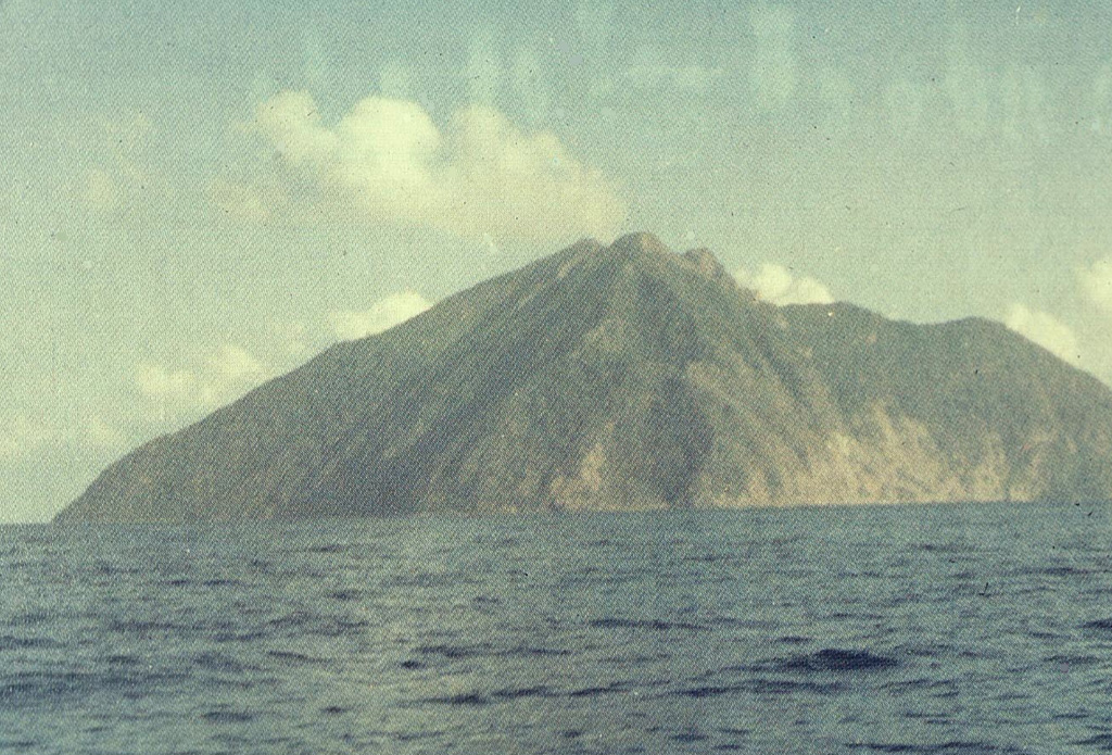 Batu Tara, seen here from the SE, is a small 3-km-wide island that is the summit of a large stratovolcano that rises from the Flores Sea about 50 km north of Lembata (formerly Lomblen) Island.  The summit of the volcano is cut by a scarp on the eastern side (right) that is similar to the Sciara del Fuoco on Italy's Stromboli Island.  Only a single historical eruption, during the mid-19th century, is known from Batu Tara. Photo by O. Rukman, 1981 (Volcanological Survey of Indonesia).