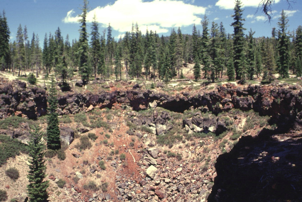 This crater on the SE rim of Medicine Lake caldera formed around 5,100 years ago. The eruption produced tephra and spatter with localized lava flows from a NE-trending alignment of pit craters. Photo by Lee Siebert, 1998 (Smithsonian Institution).