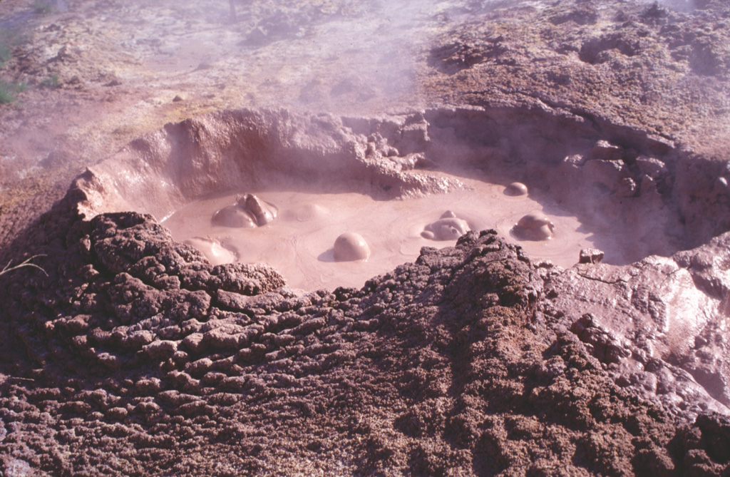 Bubbling mudpots are abundant in the Coso Hot Springs on the eastern margin of the Coso volcanic field.  The hot springs occur along faults at the margins of a horst capped by rhyolitic rocks and are associated with fumaroles, mudpots, and widespread areas of hydrothermally altered ground. Photo by Paul Kimberly, 1997 (Smithsonian Institution).