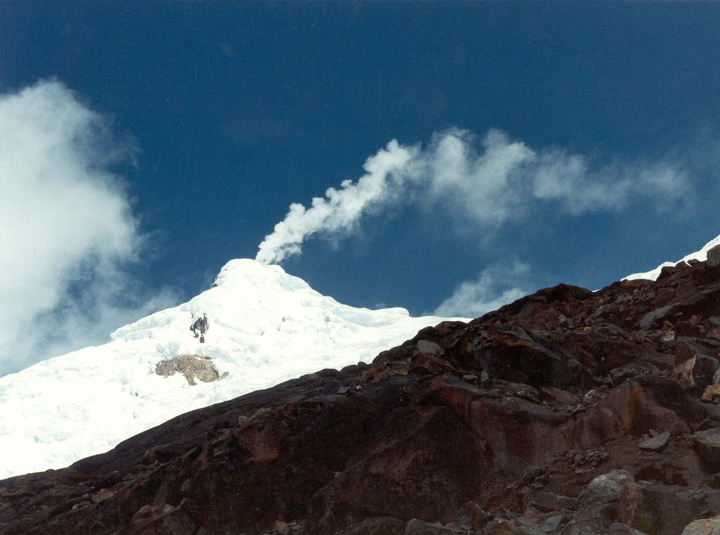 A gas plume rises above the glaciated Nevado del Huila Pico Central, seen here from the east in September 1996. Long-term, persistent, gas plumes occurred prior to the onset of eruptive activity in 2007. Before then, only a single 16th century eruption was known during historical time. Photo by Bernardo Pulgarín, 1996 (INGEOMINAS, Colombia).