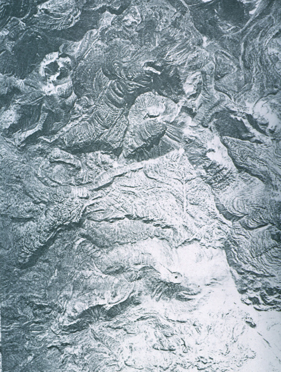 An aerial view looks down on the andesitic-dacitic lava domes that form the eruptive complex Laguna Escondida in Cordón Puntas Negras. Photo by Instituto Geográfico Militar, courtesy of Oscar González-Ferrán (University of Chile).