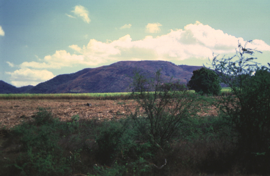 The summit of Cerro las Tablas contains a chain of three N-S-trending craters and is located west of Cerro Singüil in the interior valley of El Salvador. Cerro las Tablas is the highest feature of the Cerro Singüil volcanic field and is seen here from the west. Photo by Giuseppina Kysar, 1999 (Smithsonian Institution).