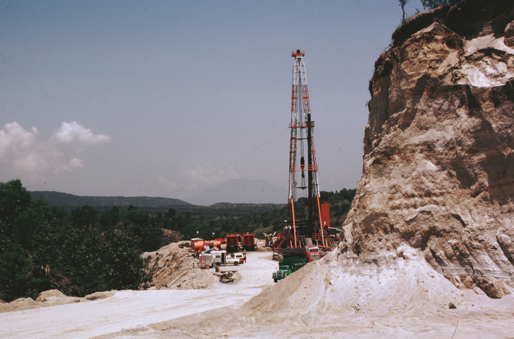 The Sierra La Primavera complex has been the site of extensive geothermal development. The drill rig here is at well PR-5, located near the center of the caldera just south of the Mesa El Nejahuete lava dome. Surface exposures in this location consist of tephra-rich lacustrine sediments. Photo by Pat Dobson, 1982 (Lawrence Berkeley National Laboratory).