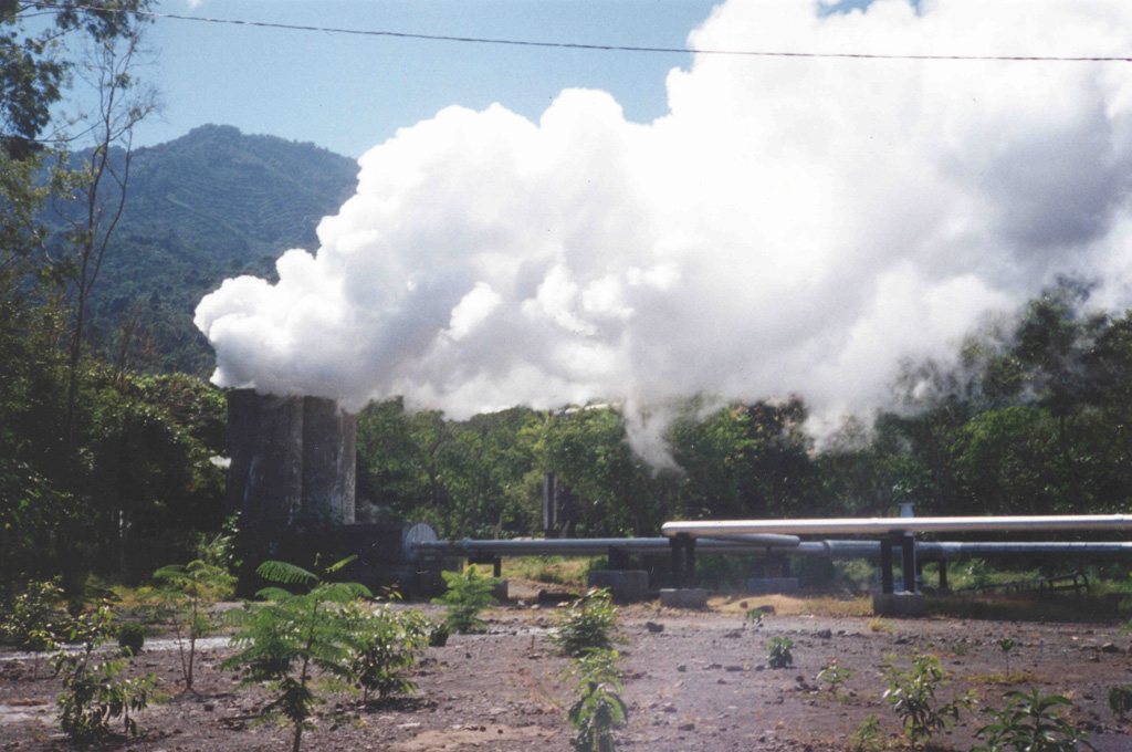 Steam plumes rise from the AH-16 production well at the Ahuachapán geothermal field. The Ahuachapán field, producing since 1975, is a high-temperature initially water-dominated system located on the flank of Laguna Verde volcano about 2 km NW of the summit. Photo by Pat Dobson, 1999 (Lawrence Berkeley National Laboratory).