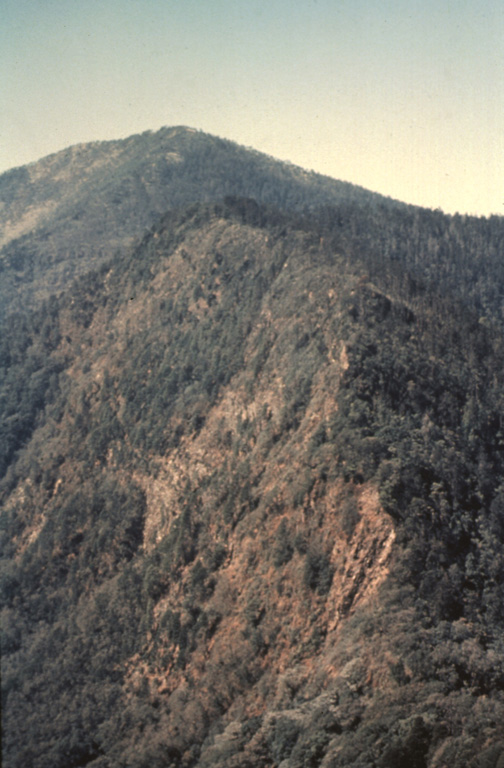 This view looks to the south from near the summit of Volcán de Zunil towards Volcán Santo Tomás. Geothermal fields are located along the ridge between Santo Tomás and Zunil.  Photo by Bill Rose, 1977(Michigan Technological University).