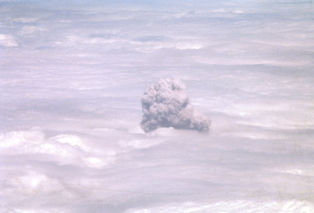 A convecting ash-bearing eruption cloud from Telica volcano punches through a low cloud layer in February 1982.  Continuous white vapor columns with occasional ash were observed beginning in late November 1982, and small gas-and-ash eruptions took place in late December and early January.  Large eruptions on February 12 and 19 sent clouds to 3.7-4.3 and 3.5 km above sea level, respectively.  Eruptive activity ended on March 2. Photo by Bill Rose, 1982 (Michigan Technological University).