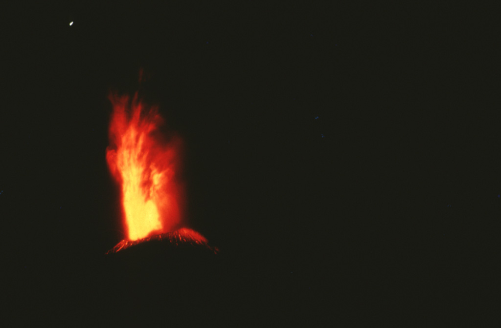 An incandescent eruption column rises above the summit of Cerro Negro in 1971.  Major explosive eruptions February 3-14, primarily from the central vent, produced extensive crop damage over a 5000 km2 area and enlarged the summit crater from 150 to 400 m diameter.  Photo by Jaime Incer, 1971.