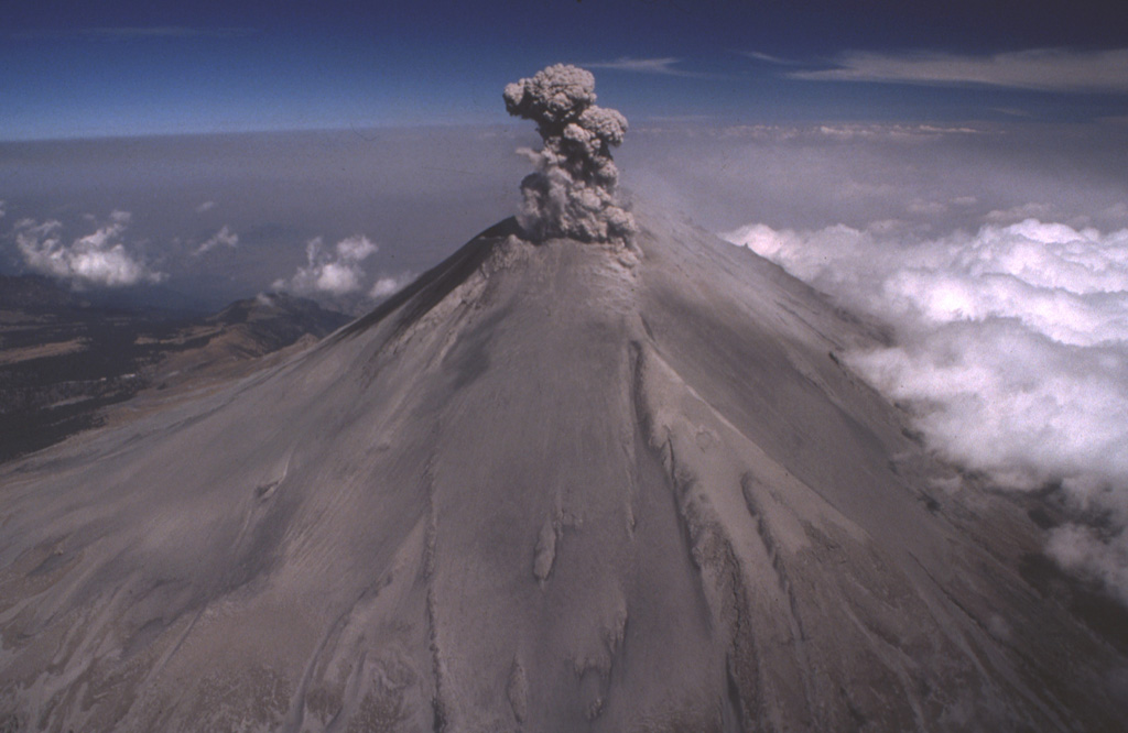 Ash from previous explosions covers the slopes of Popocatépetl on 21 February 1995, as another ash plume rises above the summit crater in this aerial view from the south. Repeated small-to-moderate eruptions had begun on 21 December 1994. The renewal of eruptive activity after a quiescence of about a half century prompted the initial temporary evacuation of 50,000 people living in towns east of the volcano. Photo by Hugo Delgado-Granados, 1995 (Universidad Nacional Autónoma de México).