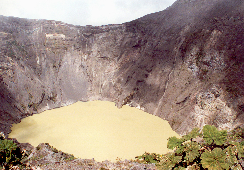 A lake occupies one of the Irazú summit craters (seen here from the southern crater rim in 1996), which has been the source of many recent eruptions. The first well-documented eruption of Irazú occurred in 1723, and frequent explosive eruptions have occurred since. Ashfall from its last major eruption during 1963-65 caused significant disruption to San José and surrounding areas. Photo by José Enrique Valverde Sanabria, 1996 (courtesy of Eduardo Malavassi, OVSICORI-UNA).