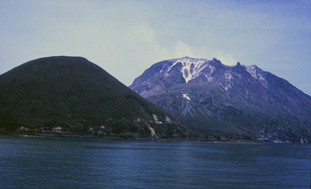 SatsumaIwojima, seen here from the SW, is a post-caldera island constructed on the NW margin of Kikai caldera. Iwodake (Iodake). To the right is a rhyolite lava dome and Inamuradake (left) is a scoria cone. Shallow submarine eruptions have also occurred following the formation of the caldera about 6,300 years ago. Photo by Yasuo Miyabuchi, 1996 (Forestry and Forest Products Research Institute, Kyushu).