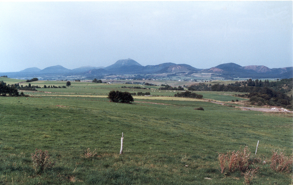The central part of the Chaîne des Puys volcanic chain in the Auvergne region of France from the SW. Puy de Dôme is the rounded peak in the center, Puy de Côme is at the left, and Puy de Laschamp is the scoria cone at the right. The N-S-trending chain of basaltic and trachytic cones, basaltic maars, and trachytic lava domes in France's Massif Central has been active into the Holocene. The latest well-documented activity took place about 6,000 years ago. Photo by Ichio Moriya (Kanazawa University).
