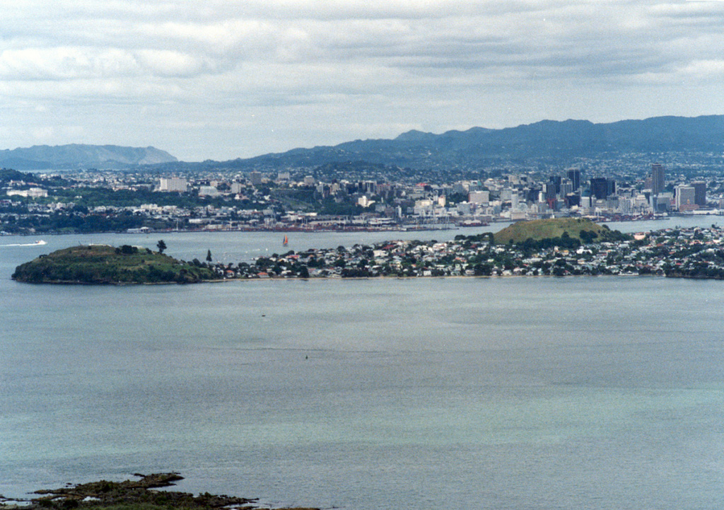 New Zealand's largest city, Auckland / Tamaki Makaurau, is built on the 600 km2 Auckland Volcanic Field. This view looking SW from the summit of Rangitoto volcano shows cones on a peninsula extending into Waitemata Harbor with the city center behind it. North Head (left) and Mount Victoria (right) on the peninsula are two of the more than 50 maars, tuff rings, and scoria cones that have formed in the past 193,000 years. Rangitoto is the only known Holocene volcano. Photo by Ichio Moriya (Kanazawa University).
