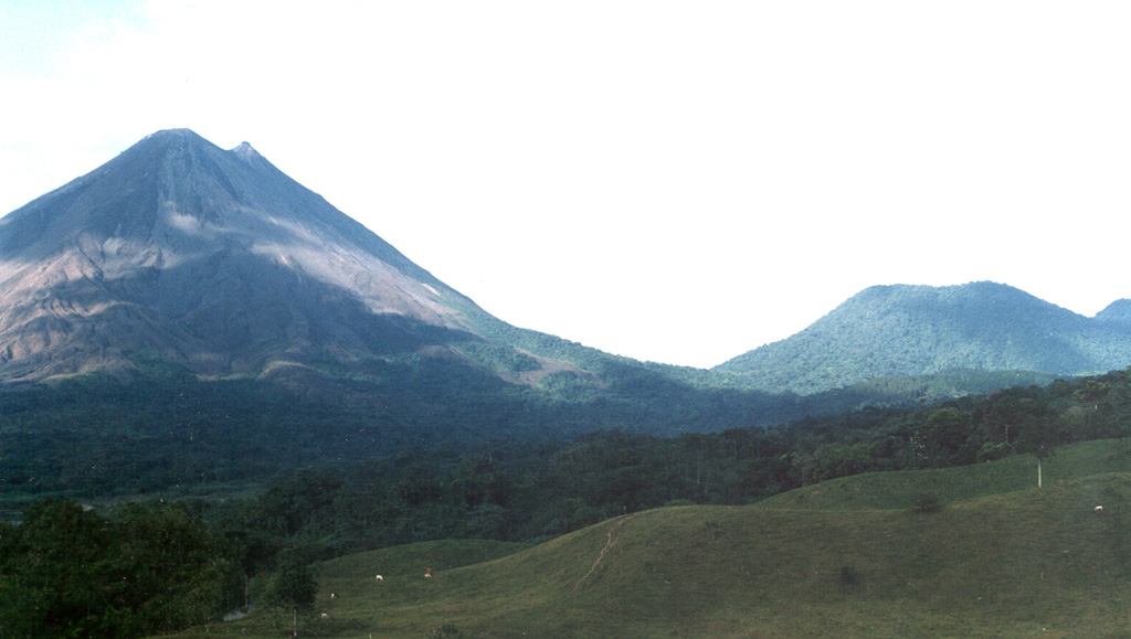 Arenal (left) and Cerro Chato (right) are seen from near El Castillo on the SW side of the volcanic complex. Activity has migrated NW since the earliest eruptions dating back to 38,000 years ago. La Espina and Chatito lava domes are out of view to the right.  Photo by Jorge Barquero (OVSICORI-UNA).