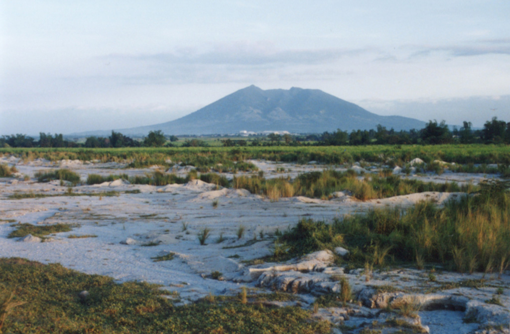 Arayat, seen here from the SW near the city of Angeles, is one of the few topographic features that rise above the flat Central Plain of Luzon Island. A broad valley can be seen here down the western flank of the volcano. There are no reports of historical eruptions from Arayat. Photo by Ichio Moriya (Kanazawa University).