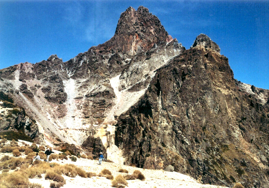 The summit pinnacle of La Malinche is seen here from the south. The summit consists of several lava domes, one of which filled the vent from the last major eruption of the volcano about 3,100 years ago. Note the people in the left foreground for scale. Photo by Renato Castro, 2000 (courtesy of José Macías, Universidad Nacional Autónoma de México).