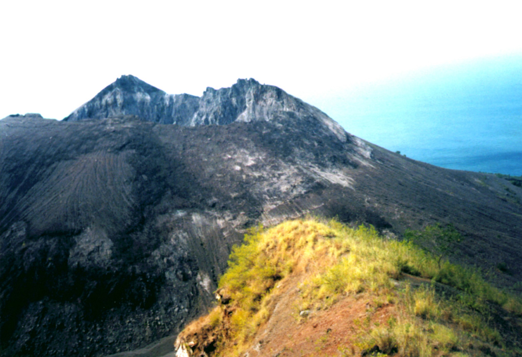 A lava dome, formed during the first historical eruption of Iliwerung volcano in 1870, occupies the summit crater of the volcano, seen here in 1979 from the rim of Ado Wajung crater.  Iliwerung forms one of the south-facing peninsulas on Lembata (formerly Lomblen) Island, and has a series of lava domes and craters along N-S and NW-SE lines.  Many of these vents, including submarine vents offshore, have erupted in historical time. Photo by Volcanological Survey of Indonesia.