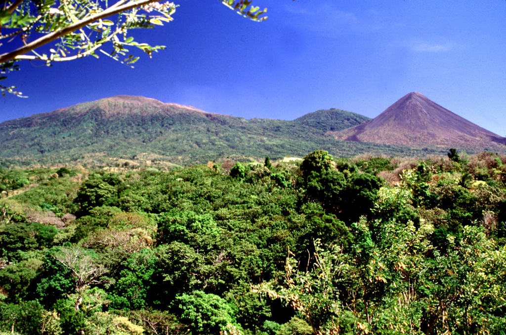 Three peaks of the Santa Ana massif can be seen from the highway between Sonsonate and San Salvador. The summit of Santa Ana volcano is to the left, the unvegetated Izalco volcano is to the right, and between them is Cerro Verde.  Photo by Lee Siebert, 2002 (Smithsonian Institution).