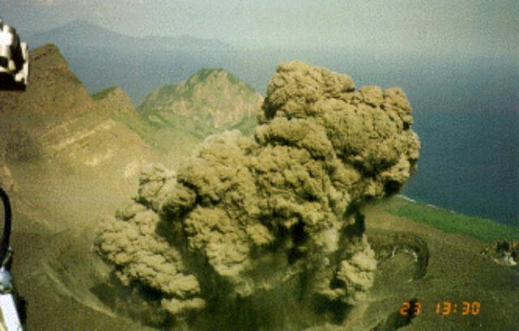 An ash plume erupts from the Suwanosejima summit crater, seen from a helicopter on 12 May 2001. Eruptions on the evening of 12 May and the morning of the 13th deposited up to 3 cm of ash in Toshima village, about 4 km NNW of the crater. After a quiet period of about 10 months eruptive activity had resumed on 19 December 2000 and continued intermittently until July 2004. Photo courtesy of Japan Meteorological Agency, 2001.