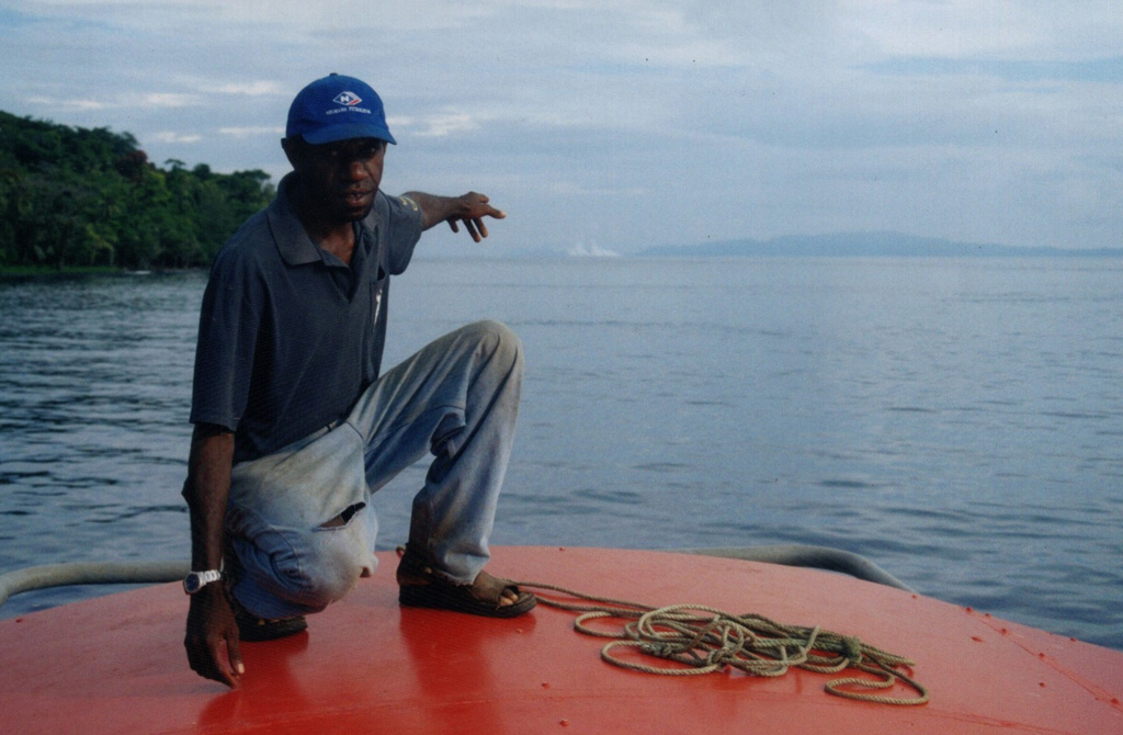 The 19 February 2004 eruption of Epi B, one of several cones of the submarine East Epi volcano, is seen here from the fishing boat Azur. Seen here from the Azur as a white area beyond the man's hand, the eruption breached the surface, ejecting water and steam. Eyewitnesses reported an eruption between 16 and 24 February, and the activity was confirmed by the infrasound recordings. Copyrighted photo by crew of Azur, 2004 (courtesy of IRD, Noumea, New Caledonia).