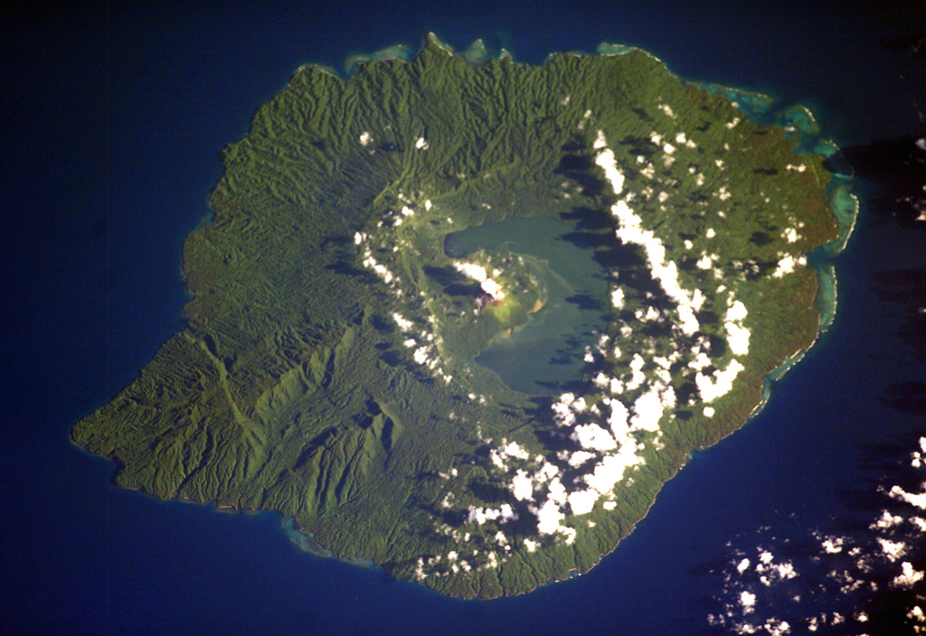 Crescent-shaped Lake Letas partially fills the summit caldera of Gaua volcano, curving around the historically active post-caldera Mount Garat. Several young lava flows from flank vents reached the coast and form the smoother areas along the flanks of the volcano. The 6 x 9 km caldera is bound by a series of discontinuous, bifurcating faults. The dissected terrain on the SW (lower left) is part of an older series of tuff cones and lavas. NASA International Space Station image ISS006-E-40036, 2003 (http://eol.jsc.nasa.gov/).
