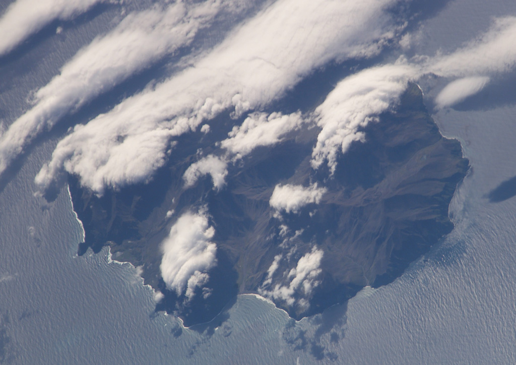Ile de l'Est, the easternmost island in the Crozet archipelago, is seen in this NASA International Space Station image (N to the top). The glacially-eroded volcano contains about a half dozen young scoria cones of possible Holocene age concentrated on its E flank. Cape Itaine forms the small peninsula on the SW side of the island (bottom left), and Abondance Bay is at the bottom center. NASA International Space Station image ISS006-E-37992, 2003 (http://eol.jsc.nasa.gov/).
