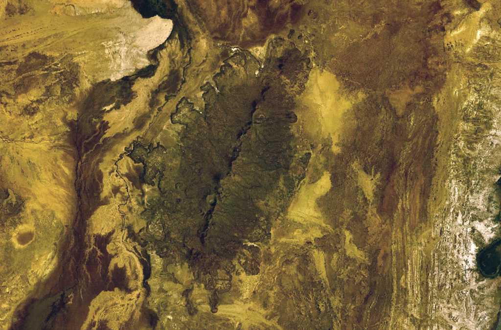The fissure-controlled Korath Range is an isolated group of tuff cones and lava flows in southern Ethiopia that were erupted along the Turkana Rift. The lava flows traveled up to about 5 km with visible lobate margins, most prominently on the W flanks. NASA Landsat 7 image (worldwind.arc.nasa.gov)