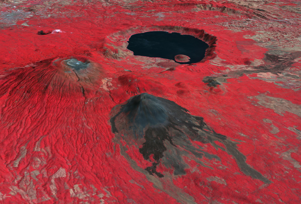 This false-color oblique DEM overlain by a thermal infrared ASTER image shows Santa Ana volcano (middle left), Izalco volcano (center), and the roughly 5.5 x 6 km Coatepeque caldera lake from the SW. The summit of Santa Ana has series of nested craters, and a NW-SE-trending fissure across the edifice. Lava flows were recently emplaced across the southern flanks of Izalco. The grayish area at the far upper left is the city of Santa Ana, El Salvador. NASA ASTER image, 2001 (https://earthobservatory.nasa.gov/).