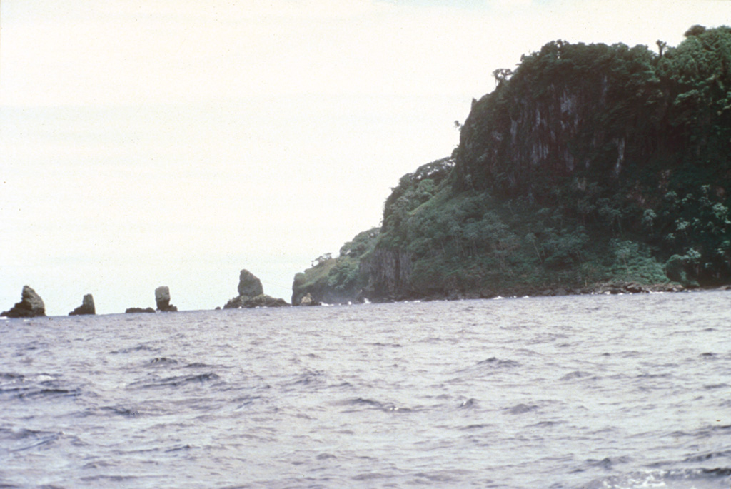 Erosional remnants of the widespread pyroclastic rock unit at the NW corner of Cocos Island form small offshore islets.  Pyroclastic rock units are thickest at the NE side of the island, south of the large trachytic lava dome between Bahia Wafer and Bahia Chathan, but are also exposed along the NW, SW, and southern coasts, and in the SW and eastern interior of the island. Photo by Pat Castillo, 1984 (Scripps Institution of Oceanography, University of California San Diego).