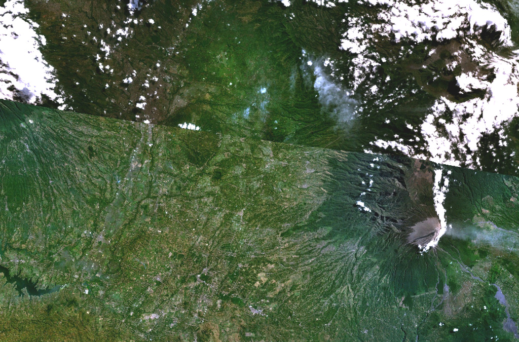 The Malang Plain, in the center of this NASA Landsat composite image (with north to the top) of eastern Java contains a group of nine ash cones, maars, and volcanic plugs.  These volcanic centers lie in a broad valley between the Tengger caldera (upper right), Semeru volcano (lower right), and Kawi-Butak volcano, in the clouds at the upper left.  Some of these may be partly parasitic to Tengger Caldera, although others have no clear connection to any specific eruption center and are situated on a distinct N-S zone of tectonic weakness.      NASA Landsat 7 image (worldwind.arc.nasa.gov)