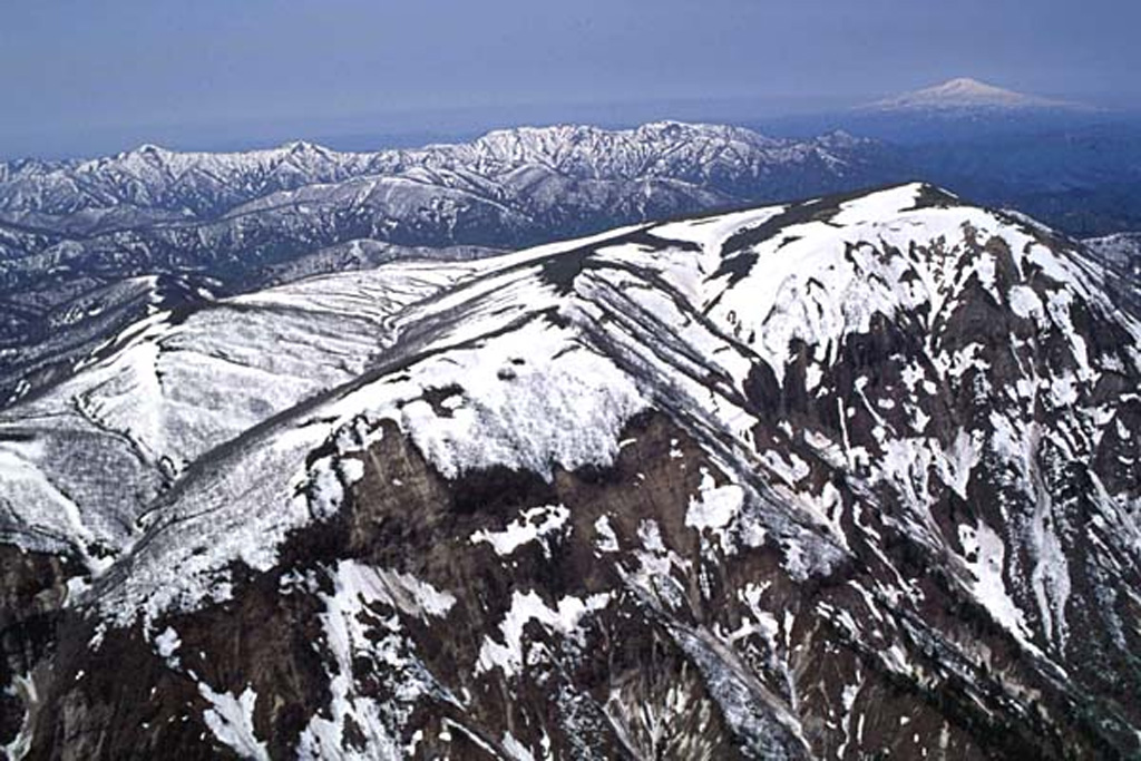 Onikobe caldera is seen here from the SE. Geysers were said to be discovered there about 1,700 years ago; both geysers and hot springs are present within the caldera. Chokaisan volcano is visible on the upper right horizon. Copyrighted photo by Hiroshi Yagi (Japanese Quaternary Volcanoes database, RIODB, http://riodb02.ibase.aist.go.jp/strata/VOL_JP/EN/index.htm and Geol Surv Japan, AIST, http://www.gsj.jp/).