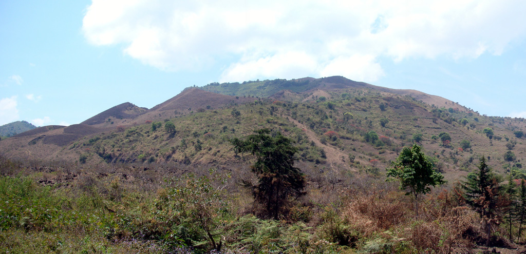 Sarabwe and Fiteko cones, visible halfway up the flank of the Kyejo volcanic complex, erupted about 1800 CE, in the latest eruption in this region. The eruption from these cones formed the Sarabwe lava flow (not clear in this picture). The cones are seen from the village of Masebe, 5 km NW from the summit. Photo by Karen Fontijn, 2008 (University of Ghent).