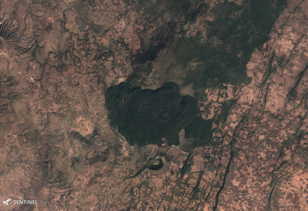 Tullu Moje has produced both mafic and silicic eruptions, with silicic volcanism emplacing explosive deposits and thick obsidian lava flows, like the flow in the center of this 5 December 2019 Sentinel-2 satellite image (N is at the top; this image is approximately 11 km across). Immediately south of the flow is the Tullu Moje cone with a roughly 700-m-wide crater. The suspected Tullu Moje caldera is south of the Gedemsa caldera. Satellite image courtesy of Copernicus Sentinel Data, 2019.
