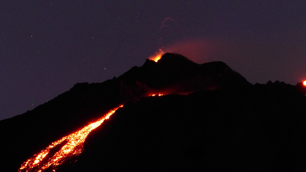 Lava flows down the upper eastern flank of Pacaya are visible in this photo from the night of 17 February 2020. Incandescent lava fountaining from the active Mackenney cone above is the source of the flow. Photo by Ailsa Naismith, 2020.