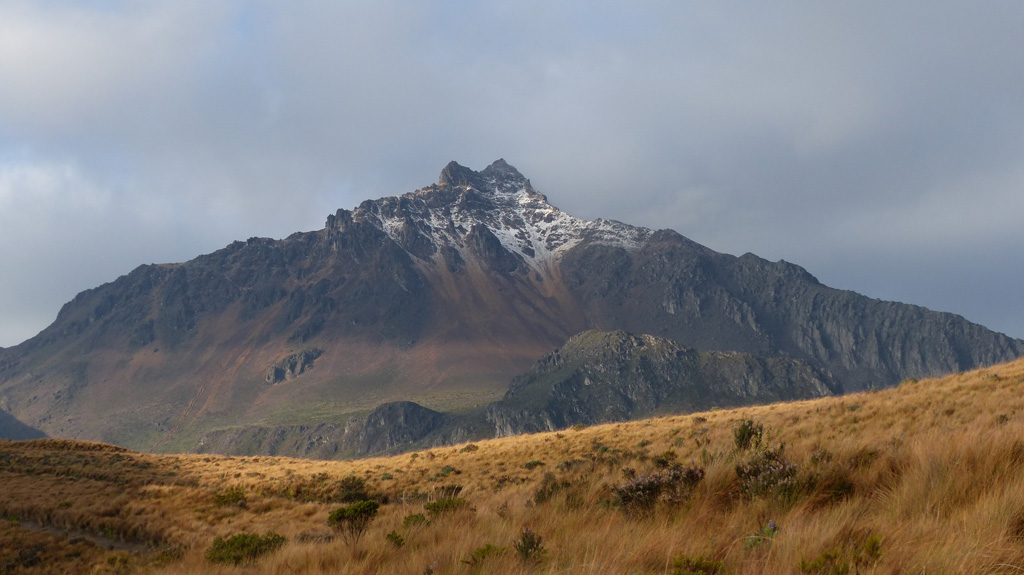 Illiniza Norte is the shorter and older of the two peaks that form the Illiniza complex in Ecuador, with Illiniza Sur out of view to the left. The substantially eroded peak is seen here from the NE in November 2015, approaching from the Interandean Valley. Photo by Ailsa Naismith, 2015.