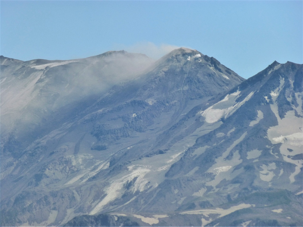 This 22 July 2014 photo of Zhupanovsky shows the Priemysh cone emitting a gas plume, seen here from the N. This cone has been active since the early Holocene and has been the site of many of the recent eruptions. The Bastion cone is to the right. Photo by Janine Krippner, 2014.