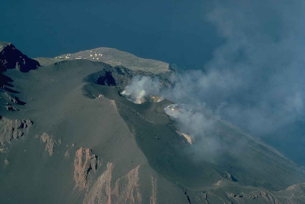The active vents of Stromboli volcano consist of a series of small craters and cones at the head of the Sciara del Fuoco, a landslide scarp that extends to the NW coast of the island.  The location and size of individual craters changes frequently during the course of Stromboli's long-duration eruption. Copyrighted photo by Katia and Maurice Krafft.