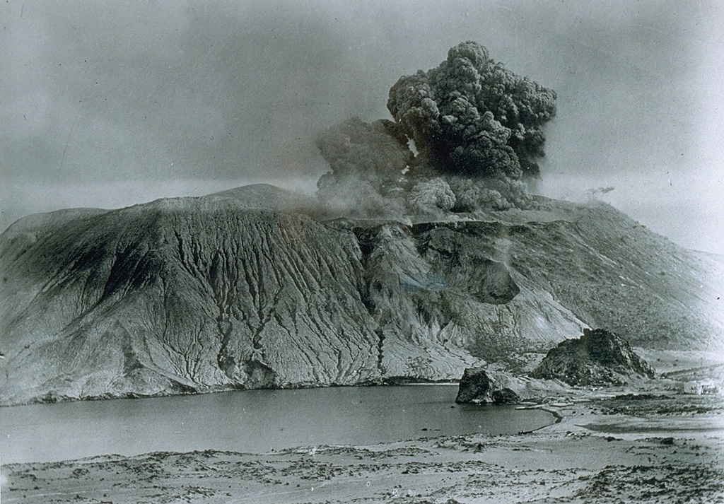 Vulcanian eruptions derive their name from the typical eruptive style of Vulcano, in Italy's Aeolian Islands.  Vulcanian eruptions consist of phreatomagmatic explosions, which eject dark, ash-laden, cauliflower-shaped eruption columns.  After the vent is cleared by the explosions, lava flows may issue from the crater or fissures on its flank.  This photo, looking to the south, shows a vulcanian eruption in 1888 from Fossa cone on the island of Vulcano. From the collection of Maurice and Katia Krafft.