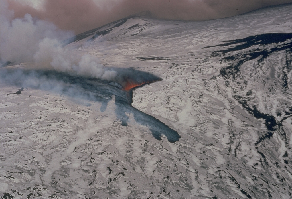 Lava flows spread over the snow-covered slopes of Etna on 17 March 1981 at the beginning of a NW-flank eruption. During the six-day eruption lava flows descended 8 km into populated areas and caused significant damage. Photo by Romolo Romano, 1981 (IIV-CNR, Catania, Italy).