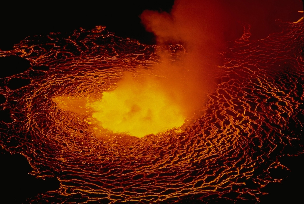 Lava lake activity resumed at the summit crater of Nyiragongo on June 21, 1982, the first eruptive activity since the dramatic draining of the lava lake in 1977.  Initial phreatic eruptions were followed by lava flow emission from two vents on the inner crater wall that rapidly formed a lava lake.  The lava lake level rose 300 m by July 23 and rose another 100 m by September 15.  The lava lake was continuing to expand in October, but no activity was seen at the beginning of November. Copyrighted photo by Katia and Maurice Krafft, 1982.