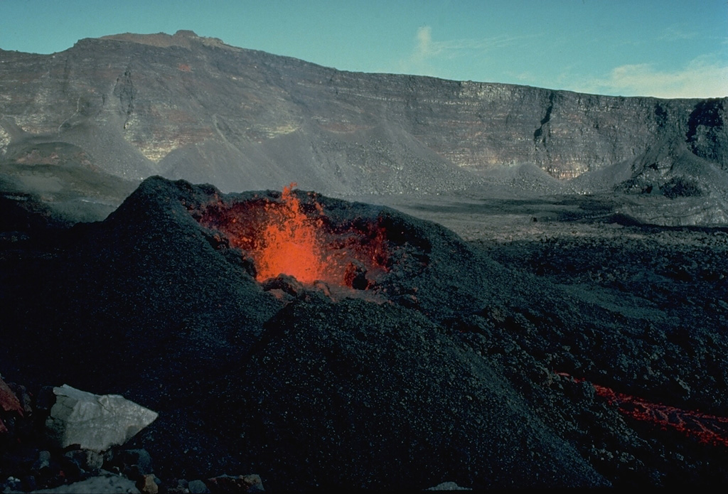 Incandescent lava rises from a spatter cone during an eruption November 4-18, 1975 in Dolomieu crater.  Subsequently, from December 18, 1975 to April 6, 1976, explosive and effusive eruptions occurred from fissures at various locations on the SE flank.  A January 18-30 lava flow originating from a SE-flank vent at 1320-m altitude traveled 5 km down to 70-m altitude and covered 250 m of the coastal highway. Copyrighted photo by Katia and Maurice Krafft, 1975.