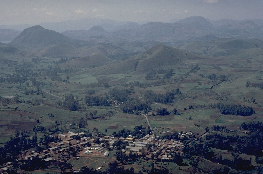 The Itasy volcanic field in central Madagascar contains a diverse assemblage of volcanic landforms, including scoria cones, lava domes, and maars.  Activity began in the Pliocene and has continued into the Holocene.   A trachytic maar was formed near Saovinandriana at the beginning of the Hololcene, and several other crater lakes are present.  Thermal activity in the form of hot springs, and mild seismicity continues at Itasy.    Copyrighted photo by Katia and Maurice Krafft, 1973.